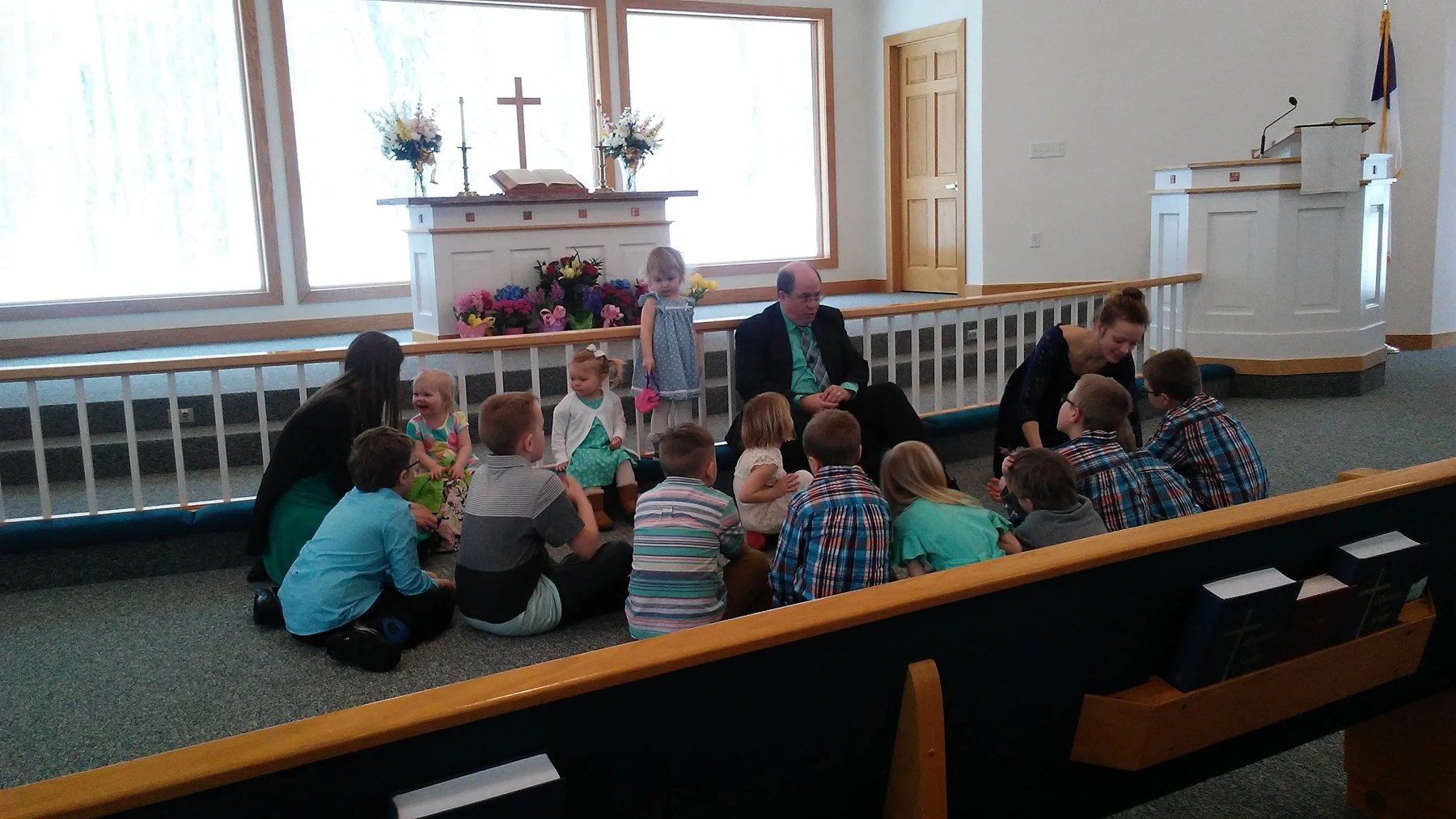 Children seated near the altar during Easter worship